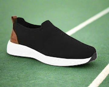 Black slip-on shoe with white sole on a white background