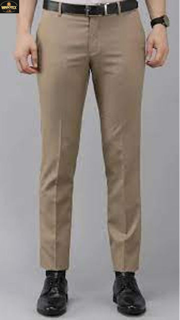 Beige pants worn by a person on a gray background