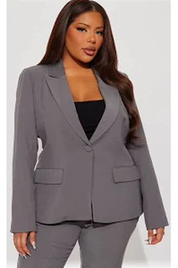 Woman wearing a gray suit jacket on a white background