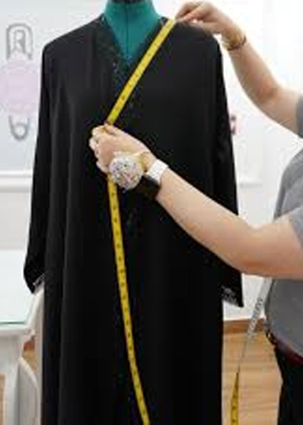 Lady measuring abaya for alteration