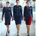 Three women in matching navy and red uniforms walking together.