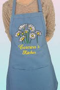 Blue apron with floral design and 'Carina's Kitchen' text on a gradient background