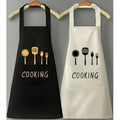 Two aprons with 'COOKING' text and utensil graphics on a gray background