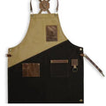 Two-tone apron with beige and black design, featuring leather accents on a white background.
