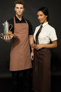 Two waiters in brown aprons standing side by side with a dark background