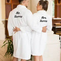Man and woman wearing a whith embroidered bath robe