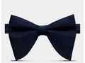 A dark navy blue pre-tied bow tie with a subtle textured weave, presented on a clean light gray background.