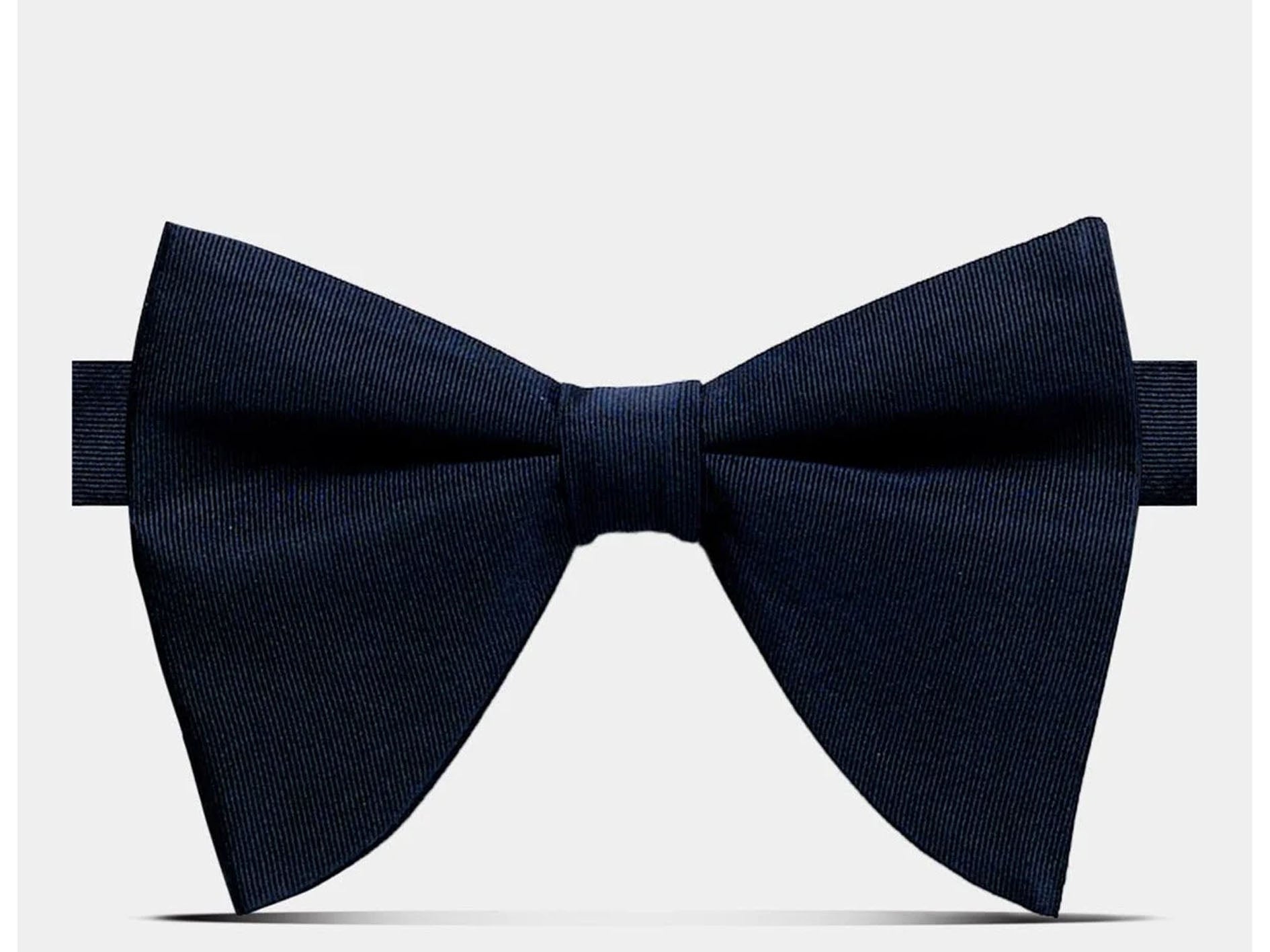 A dark navy blue pre-tied bow tie with a subtle textured weave, presented on a clean light gray background.