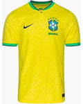 Yellow soccer jersey with Nike logo and 'Brasil' text on a white background