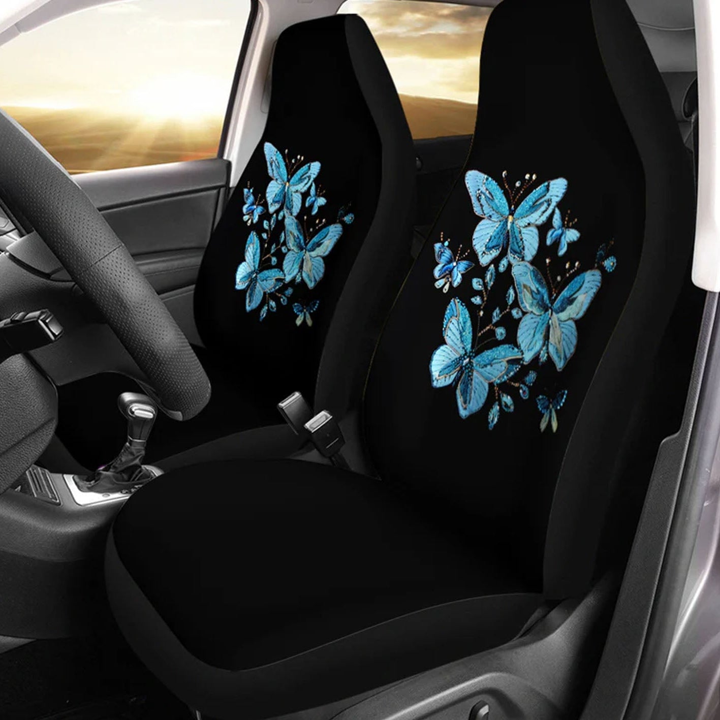 Car seat covers with blue butterfly design inside a vehicle.