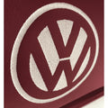 Close-up of a Volkswagen logo on a maroon background