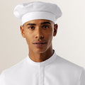 Person wearing a white uniform and hat on a plain background