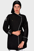 Person wearing a black chef's coat with white trim on a light gray background