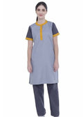 A woman modeling a short-sleeve kurta-style top in light gray with dark gray sleeves and yellow trim, paired with dark gray pants, against a plain white background.