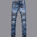 Ripped blue jeans on a gray background