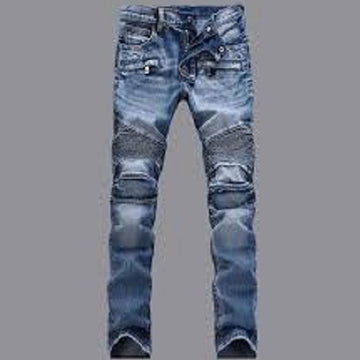 Ripped blue jeans on a gray background
