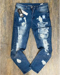 Distressed blue jeans on a wooden surface