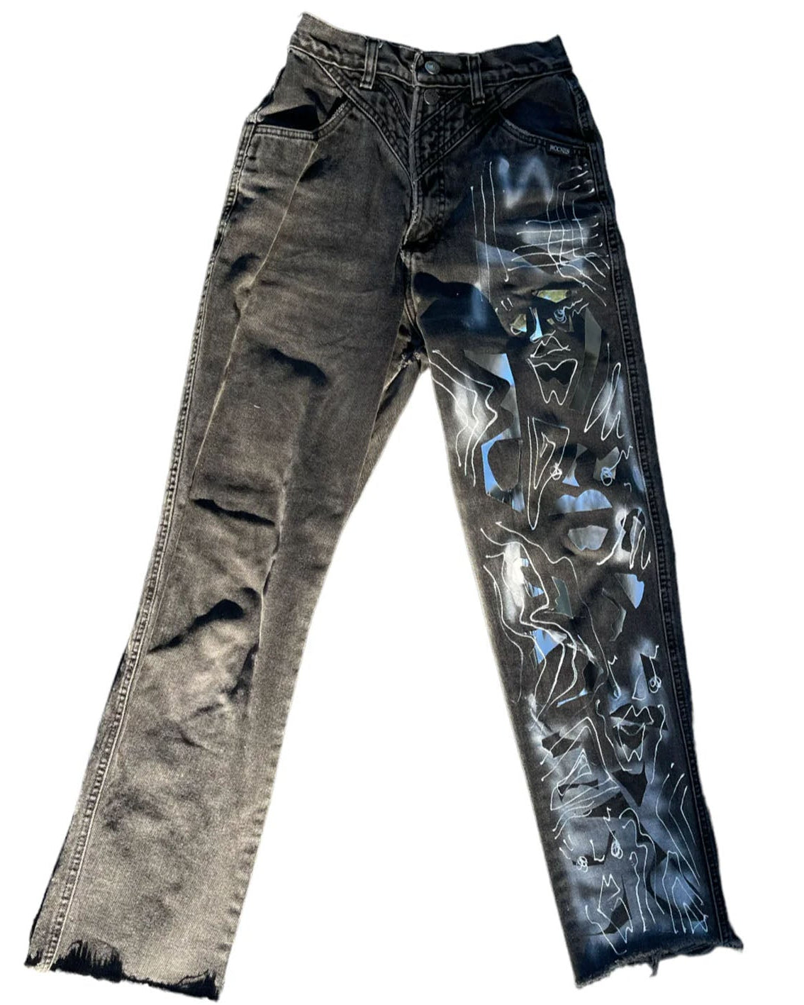 Distressed black jeans with visible wear on a white background