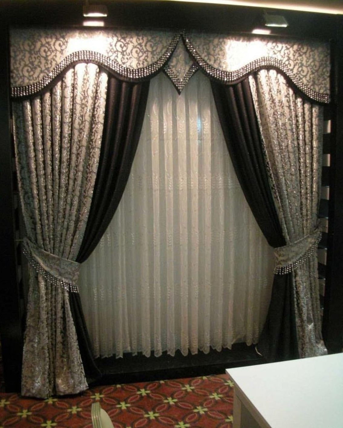 Decorative curtains with intricate patterns and a white center panel.