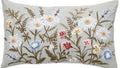 Decorative pillow with floral embroidery on a plain background