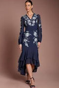 Lady wearing a navy blue dress with floral embroidered design
