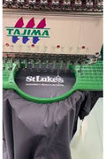 Embroidery machine with 'Tajima' branding on a white background
