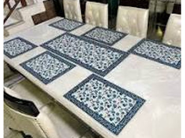 Table with blue and white checkered placemats on a dining table.
