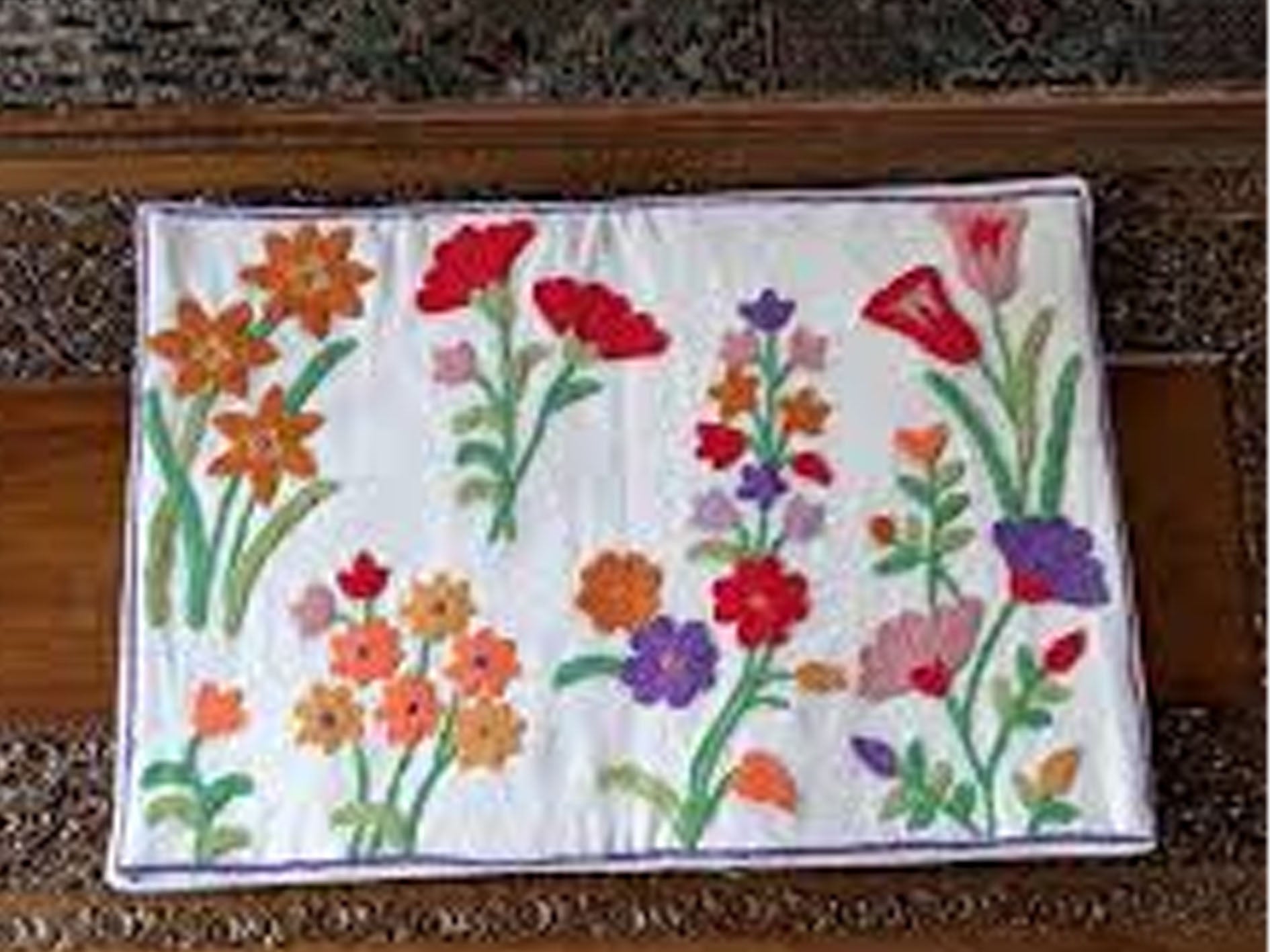 Floral patterned placemat on a wooden surface