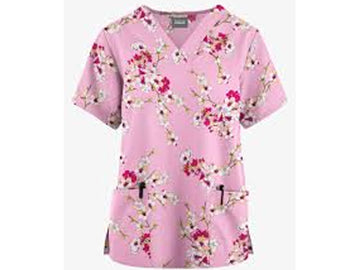 Pink floral patterned scrub top on a white background