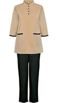 Beige top with black trim and black pants on a white background