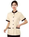 Woman wearing a beige uniform with black accents on a white background