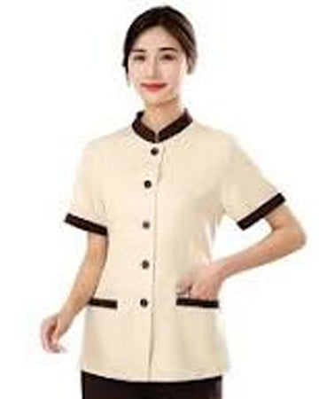 Woman wearing a beige uniform with black accents on a white background