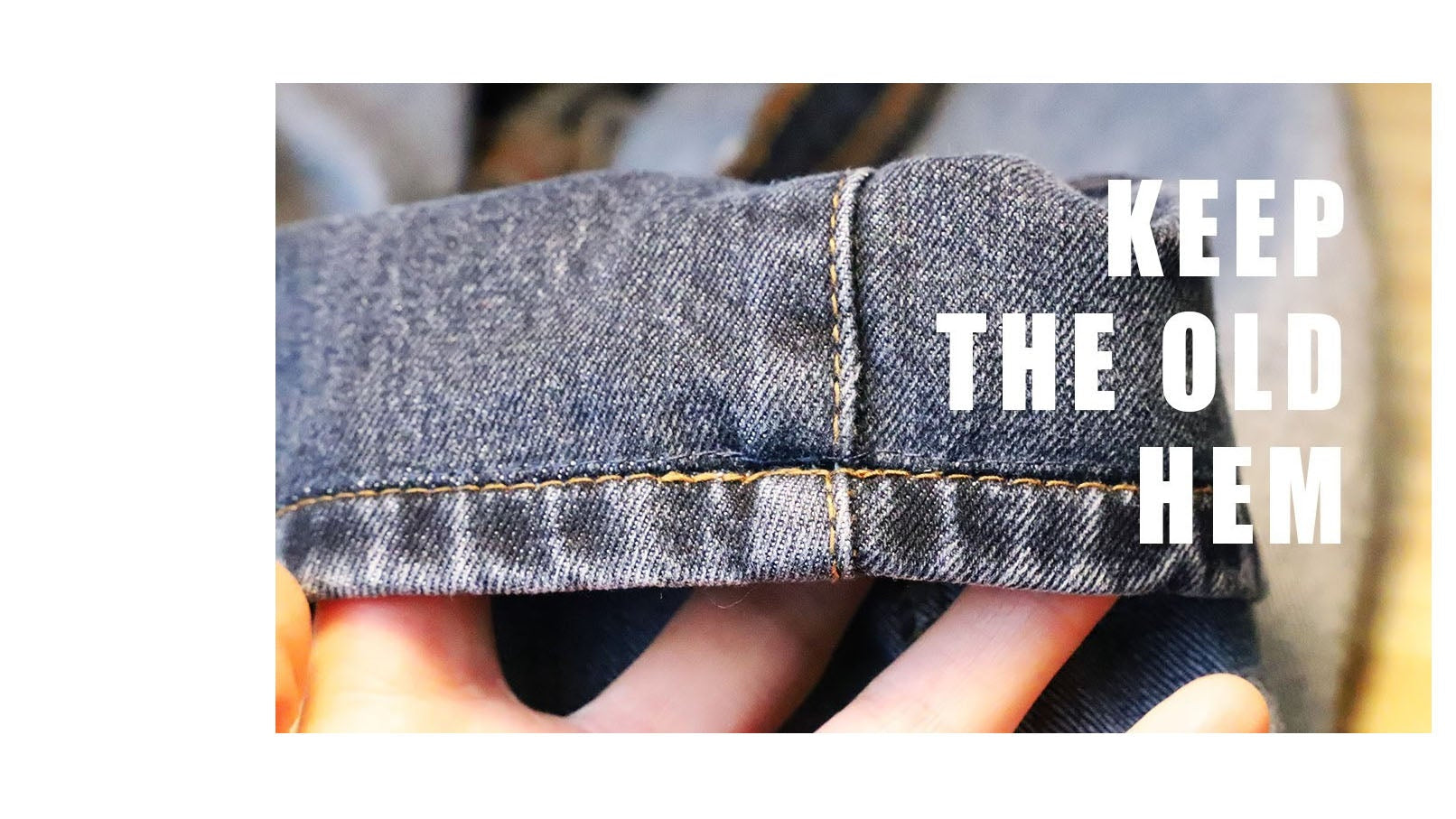 Rolled-up denim jeans with text 'KEEP THE OLD HEM' on a white background