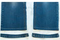 Blue jeans with a close-up of the hem on a white background