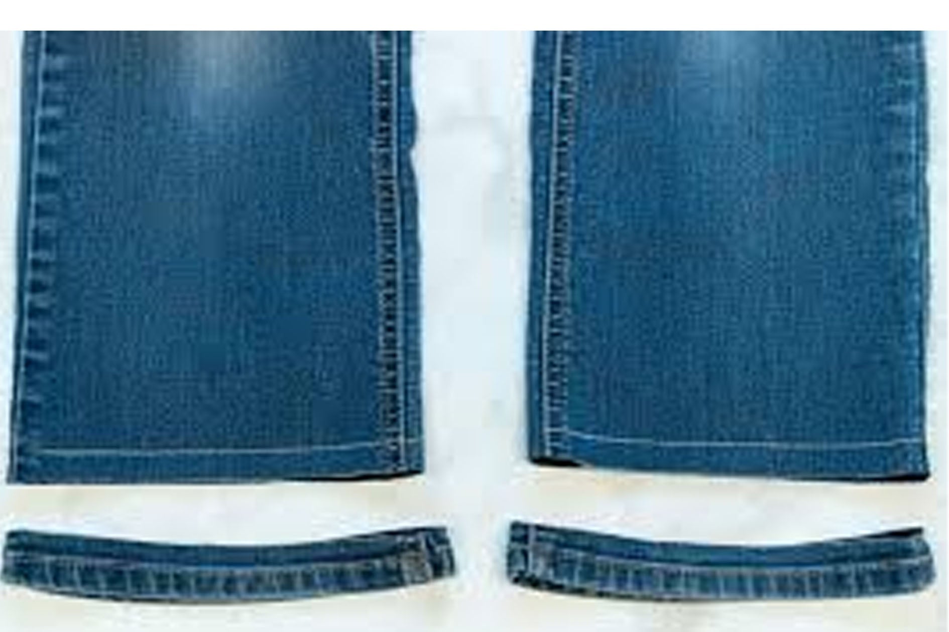 Blue jeans with a close-up of the hem on a white background
