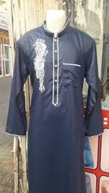 Navy blue embroidered traditional outfit on a mannequin against a blurred indoor background