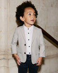 A boy wearing a beige blazer