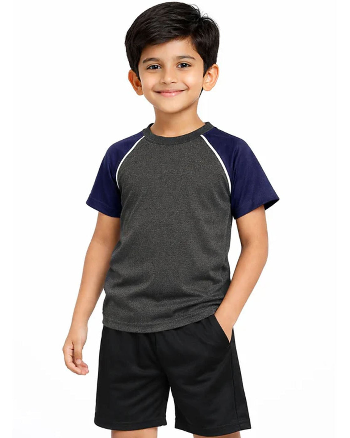 Child wearing a gray and navy shirt with black shorts on a white background