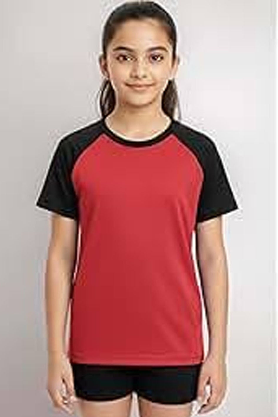 Person wearing a red and black sports outfit on a plain background