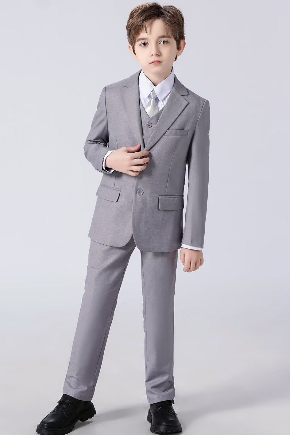 Child wearing a gray suit on a white background