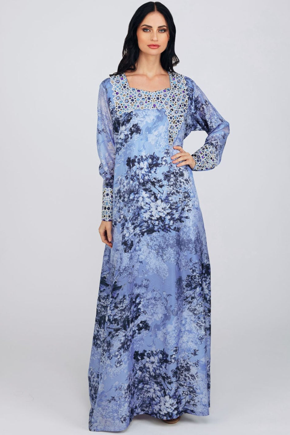 Woman wearing a long floral dress on a white background