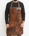 Brown leather apron worn by a person on a white background