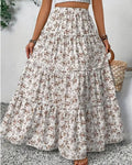 Long floral skirt worn by a person on a light gray background