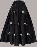 Black skirt with white cross patterns on a gray background