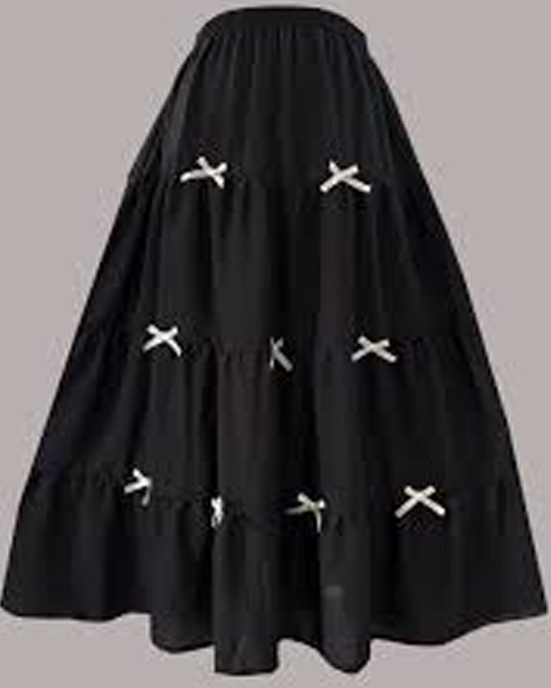 Black skirt with white cross patterns on a gray background