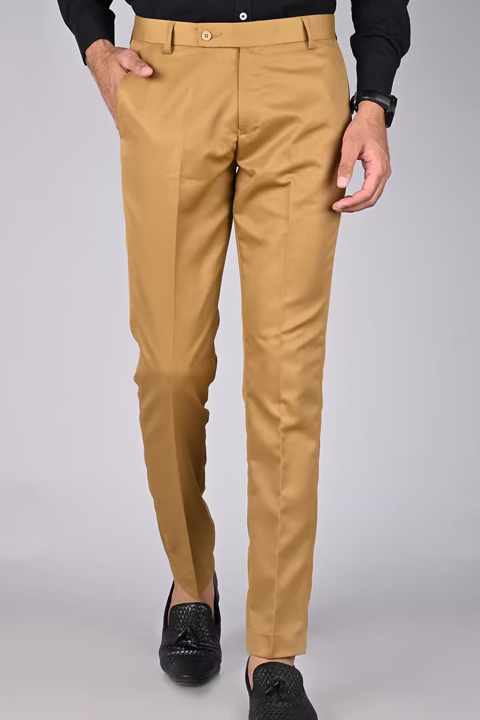 Beige pants worn by a person on a gray background