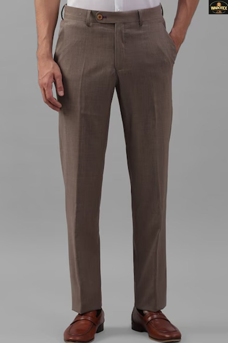 Brown dress pants worn by a person on a gray background