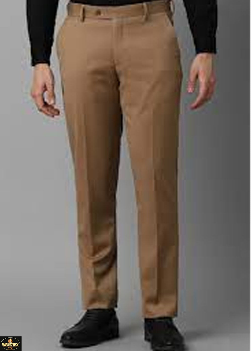 Tan pants worn by a person on a gray background