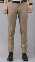 Beige pants worn by a person on a gray background