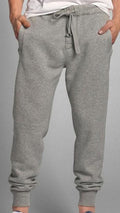 Gray sweatpants worn by a person on a gray background